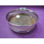 A silver plated bottle coaster of traditional form having gallery style side