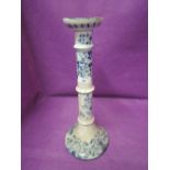 A large blue and white candle stick hand decorated standing 1ft high