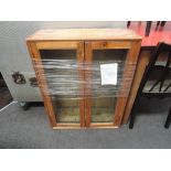 A rustic pine glazed cabinet