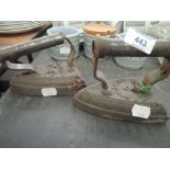 Two cast stove irons