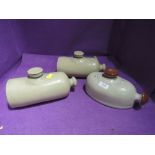 A selection of earthen ware salt glazed foot warmers