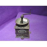An antique coffee grinder by Bullock and co