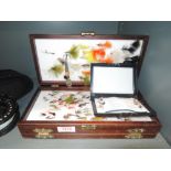 A selection of fly fishing lures and case