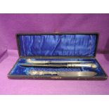 An ornate plated carving set with case