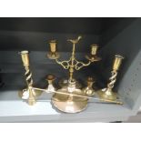 A selection of brass candle stick with various designs including twin