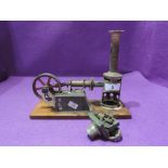 A miniature model steam or hot air engine