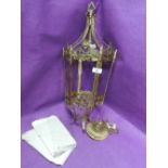 An ornate brass cast lantern style ceiling light