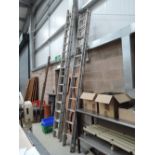 A pair of aluminium extendable ladders with roof hook