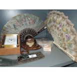 A selection of dressing table items including lace work fan