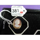 A lady's dress ring having a conche shell cameo depicting a maiden in profile in a collared mount on