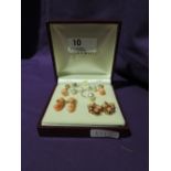 Three pairs of modern coral style stud earrings of various styles in gold plated mounts and a pair