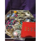 A tin of fashion costume jewellery including bangles, necklaces etc