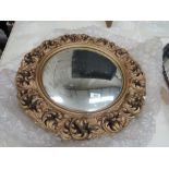 A gilt plaster wall mirror