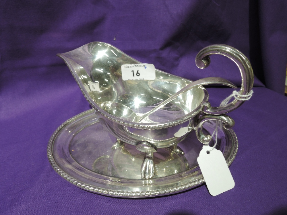 A silver plated sauce boat with saucer and ladle, all of traditional form, Viners Ltd, in original