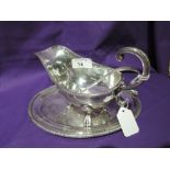 A silver plated sauce boat with saucer and ladle, all of traditional form, Viners Ltd, in original