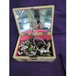 A vintage wooden jewellery box having rose decoration containing a election of costume jewellery