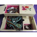 A retro painted wooden jewellery box containing a selection of costume jewellery including pin