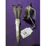 A small white metal pepperette having continental style decoration and trefoil bun feet, no marks