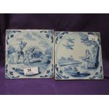 Two antique hand painted delft tiles depicting mythology scenes and giant being slain