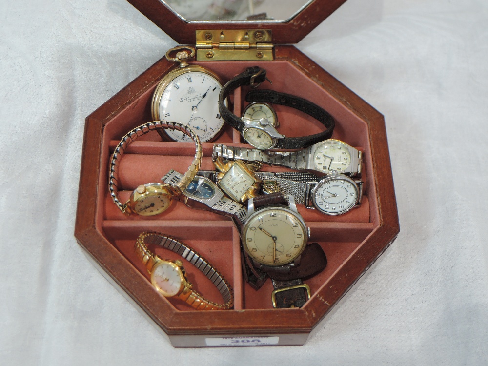 A small wooden jewellery box containing a selection of wrist watches including Rotary, Cyma and