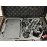 A cased QTX sound radio microphone kit