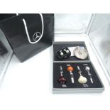 A selection of Mercedes promotional gifts, Cuff links, wine bottle stoppers and pin dish