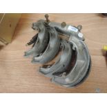 An Austin A7 Water inlet and set of brake shoes