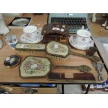 A selection of dressing table items including teacups