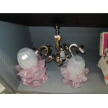 A ceiling light shade with pink and frosted glass