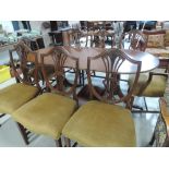 A reproduction Regency extending dining table and eight (six plus two) chairs