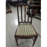 An early 20th century mahogany salon chair having slat back with Regency stripe seat, and tapered