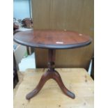 A modern dark stained pine pedestal table