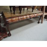 A mid 20th century walnut coffee table having wave edge and cabriole legs with claw and ball feet