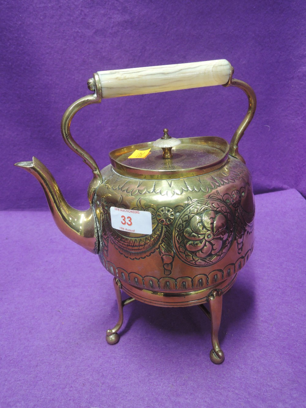 A hand worked arts and crafts design spirit burner and kettle