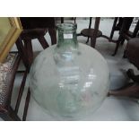 A large aqua glass carboy