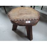 A rustic stool having leather studded seat with pictorial decoration for H.M.S. Victory 1805