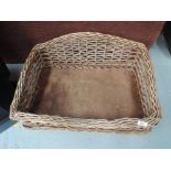 A wicker woven dog or cat basket
