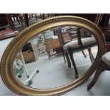 A vintage gilt frame oval wall mirror