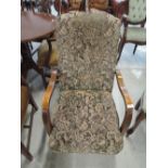 An early to mid 20th Century stained frame upholstered armchair