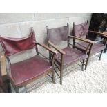 A set of three beech framed and red leather backed chairs