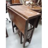An early 20th century stained frame occasional table having drop leaf top on open gate supports