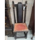 A 19th century rustic throne chair having stained frame high panel back, and bobbin frame