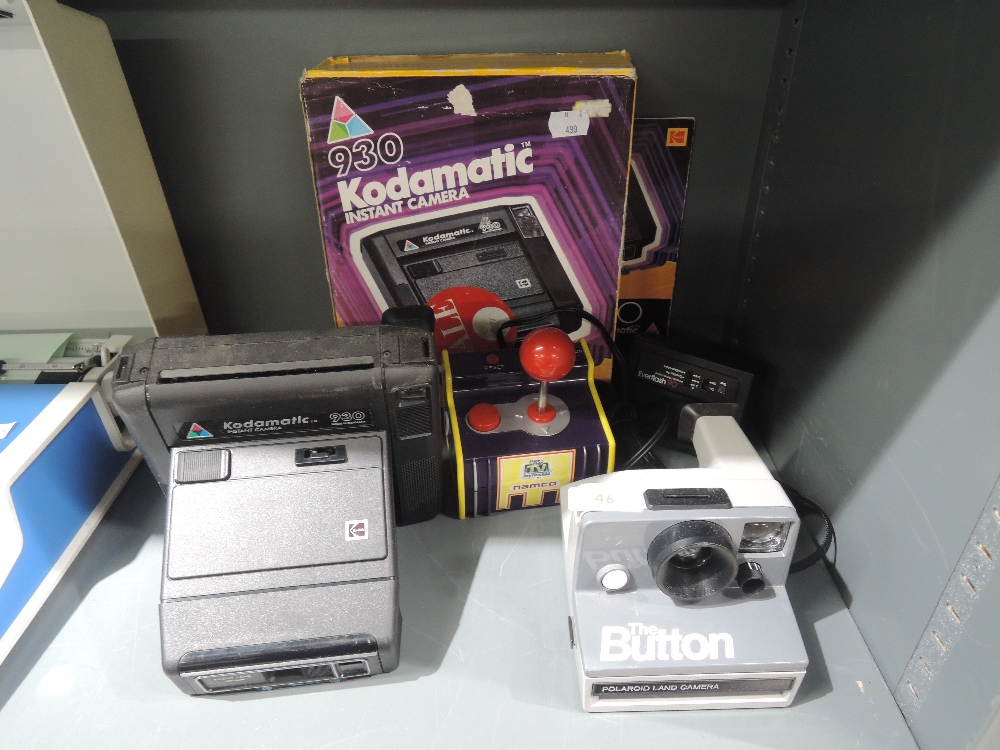 A selection of instant cameras including Kodamatic and Polariod