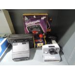 A selection of instant cameras including Kodamatic and Polariod