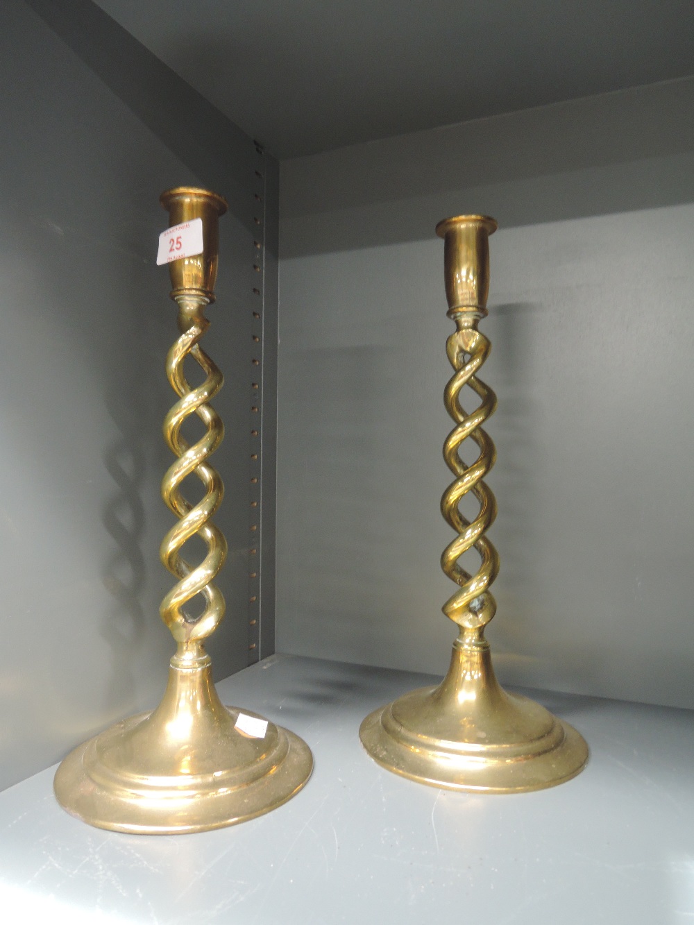 A pair of heavy brass candle sticks with helix twist stems