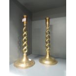 A pair of heavy brass candle sticks with helix twist stems