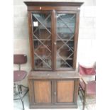 A late Victorian stained frame full height bookcase having astral glaze top over cupboard base