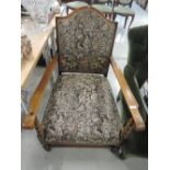 An early 20th century stained frame armchair having tapestry upholstery and bobbin supports