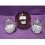 A selection of glass paper weights including Parlane