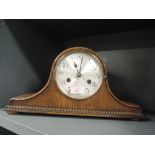 An antique mantle clock with chime in a napoleon design